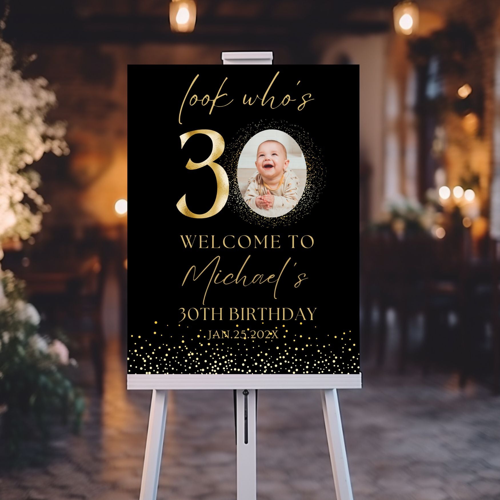 Decorative birthday sign with a child's photo on an easel against a blurred indoor background.