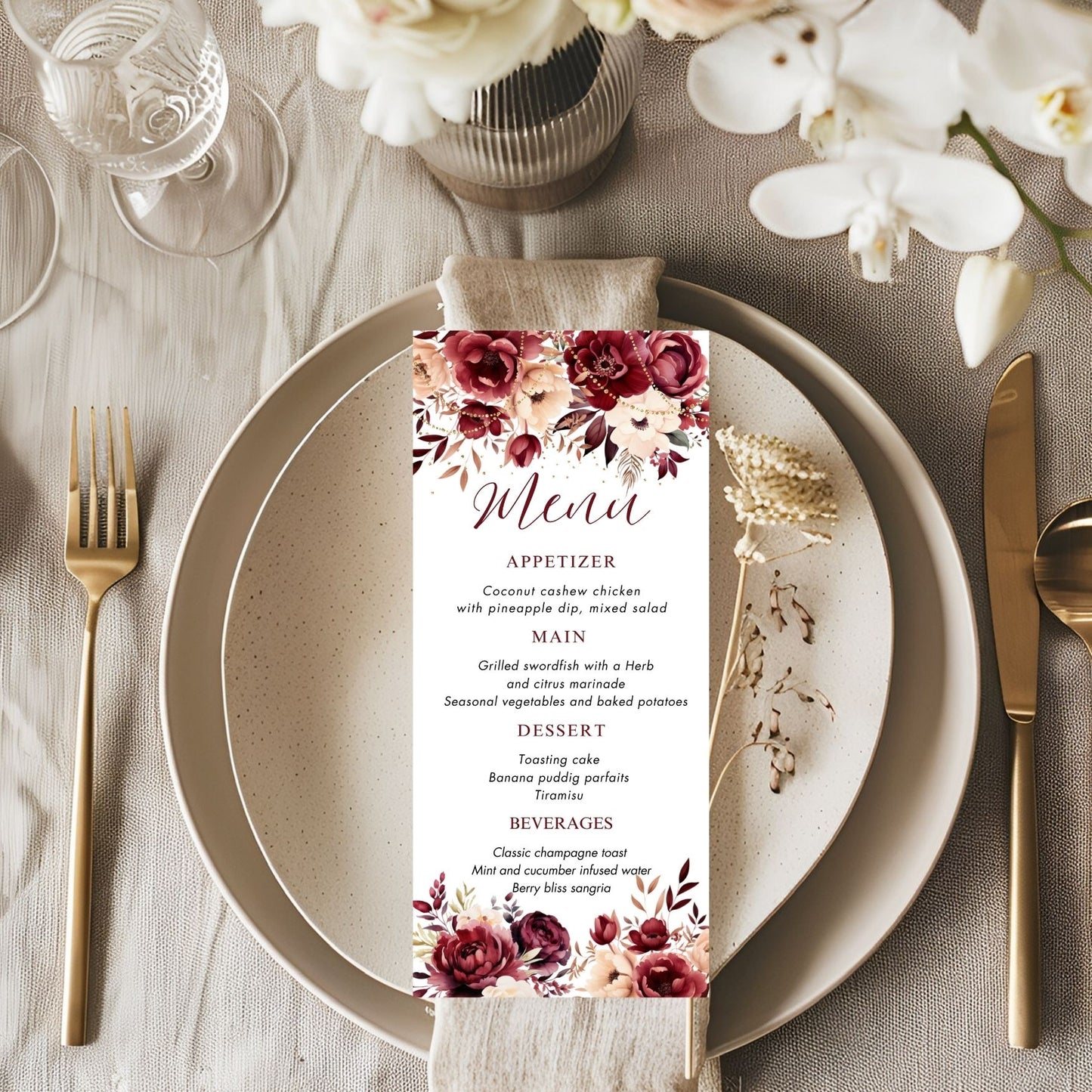 Burgundy Menu card with floral design on a table setting with plates, cutlery, and flowers.