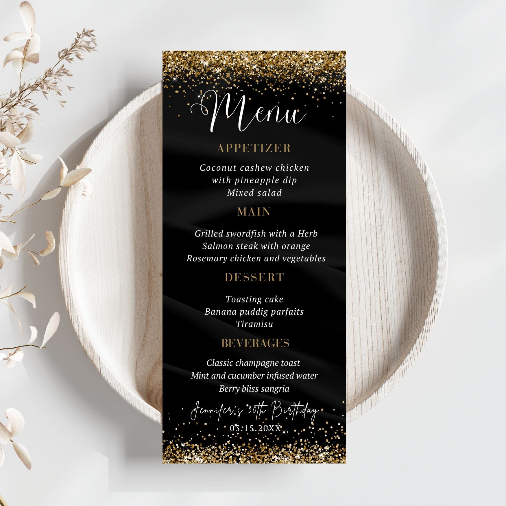 Black menu card with gold glitter text on a white plate with decorative elements.