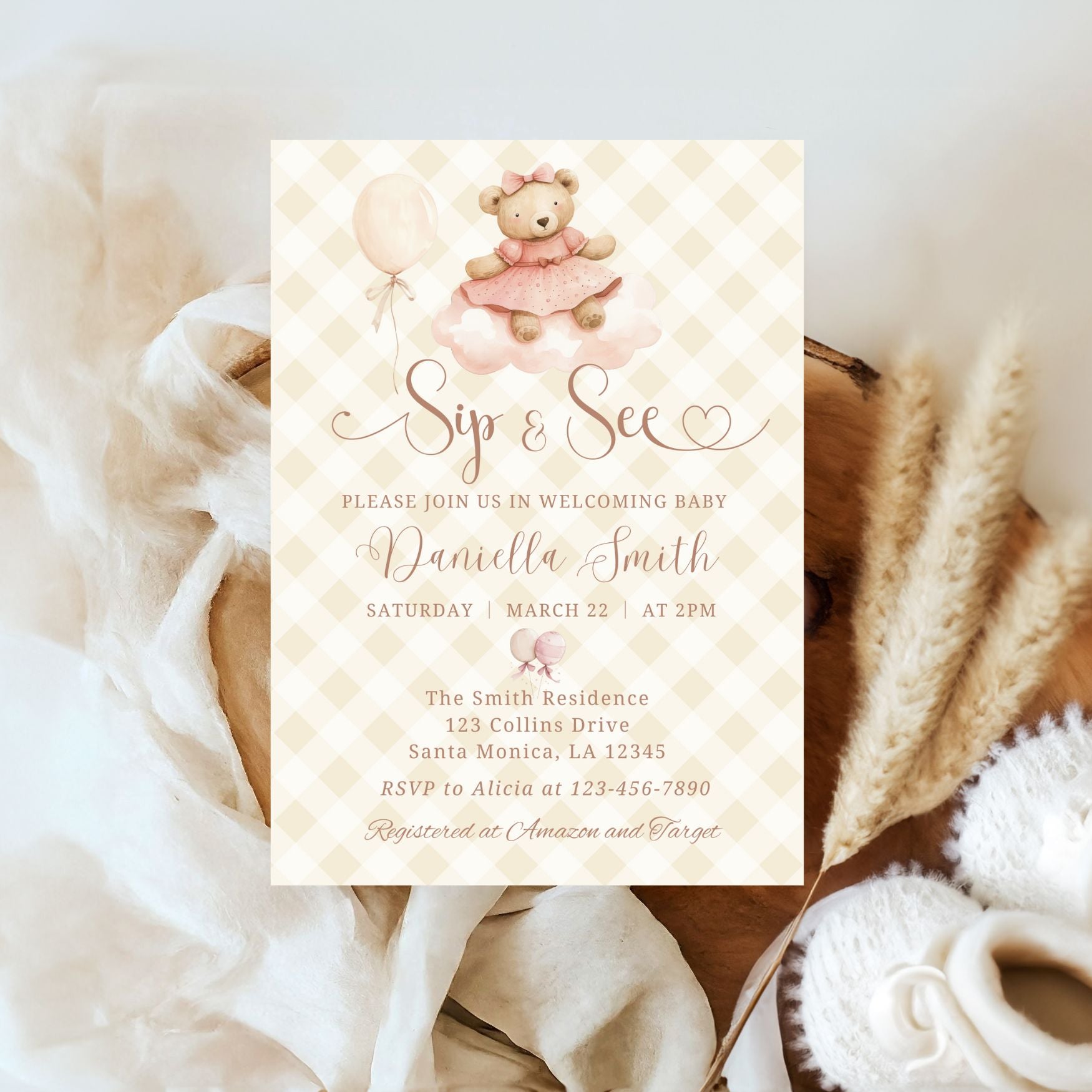Baby shower invitation with teddy bear and balloons on a textured surface