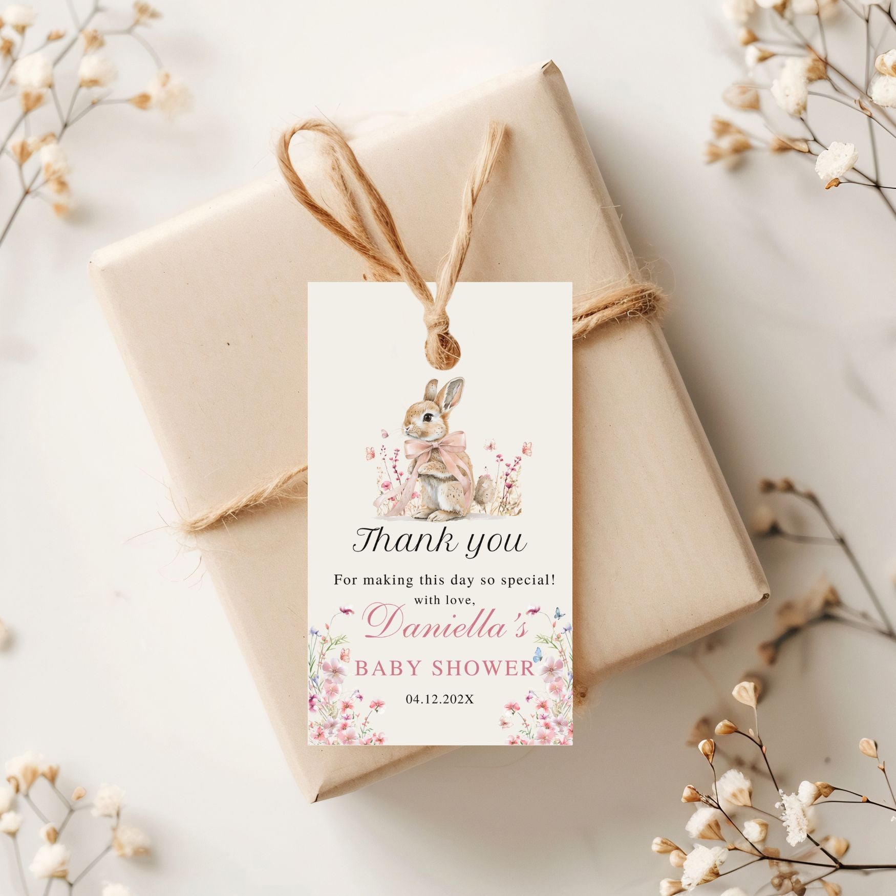 Gift box with a decorative Thank you tag for a baby shower on a light background
