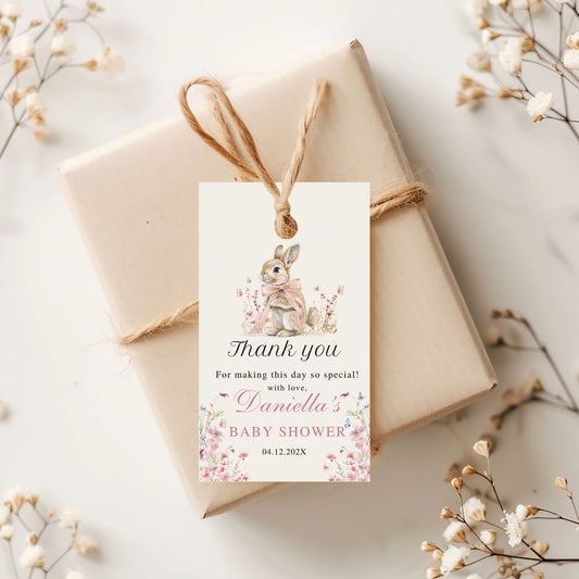 Gift box with a decorative Thank you tag for a baby shower on a light background