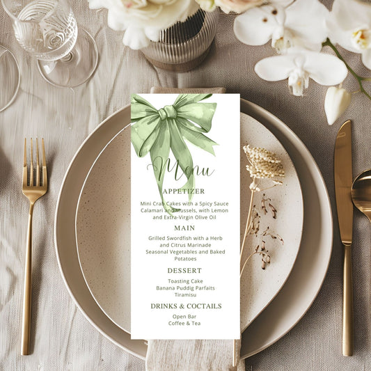 Table setting with a menu card featuring a sage green bow design.