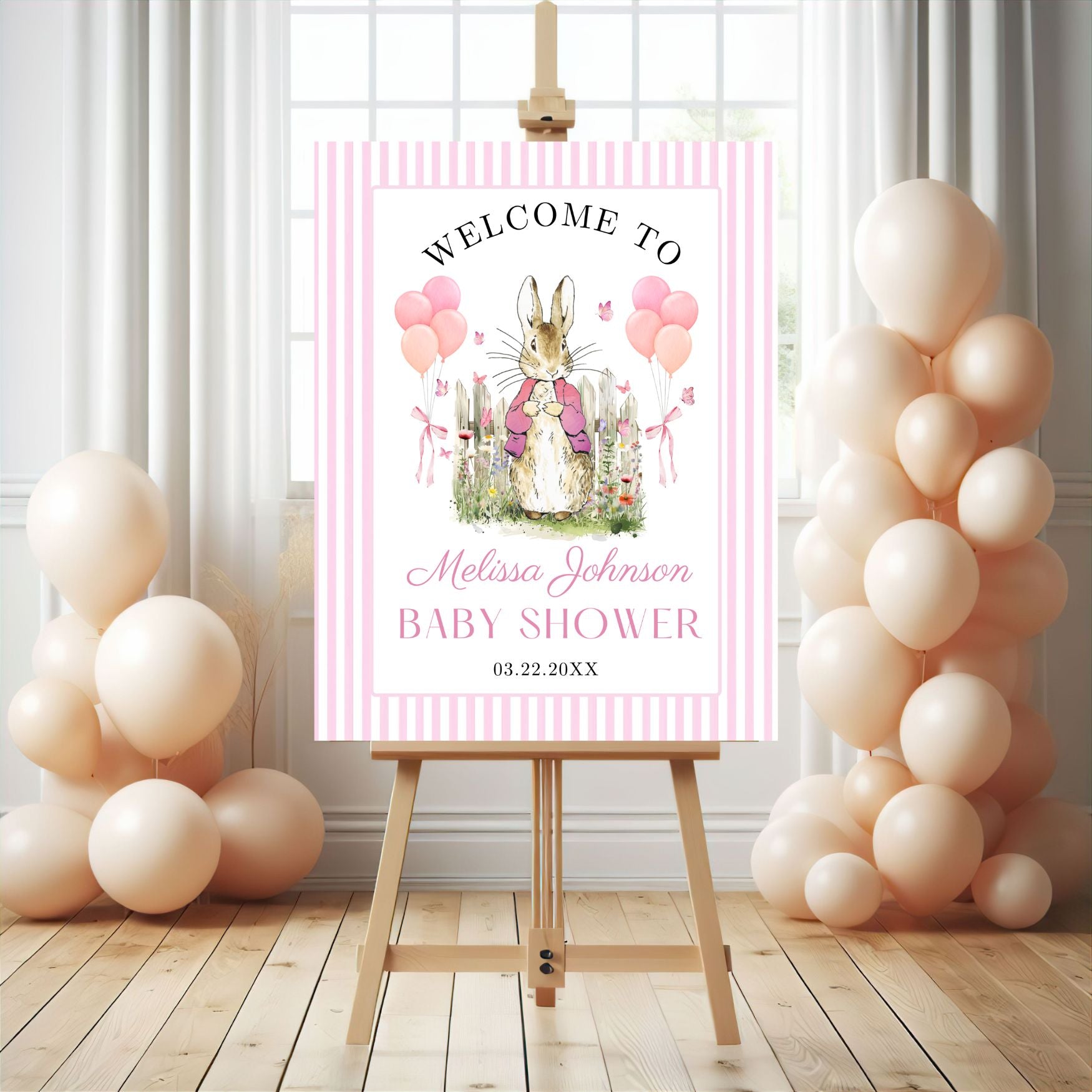Pink Peter rabbit Baby shower welcome sign with balloons on an easel