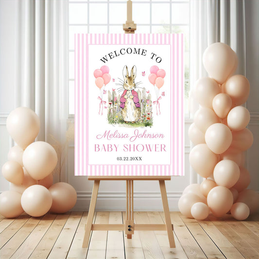 Pink Peter rabbit Baby shower welcome sign with balloons on an easel