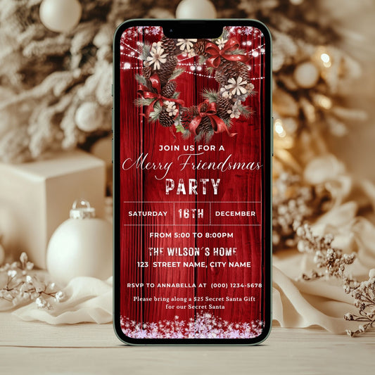 Phone screen displaying a Electronic Christmas party invitation with festive design, surrounded by holiday decorations.