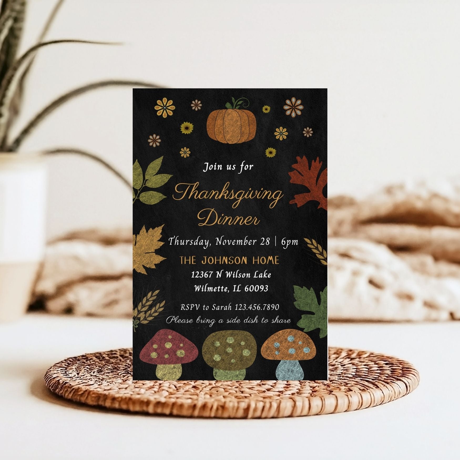 Thanksgiving dinner invitation card with autumn-themed Chalkboard  design on a woven mat.