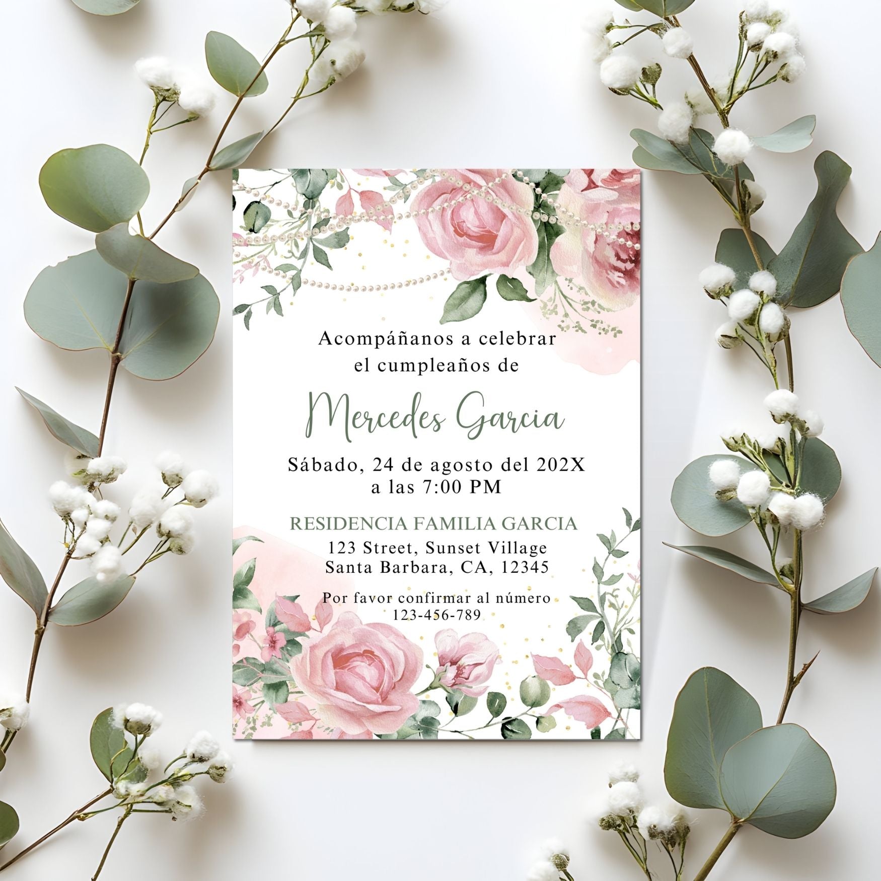 Invitation card with Pink floral and pearls design surrounded by decorative plants on a white background