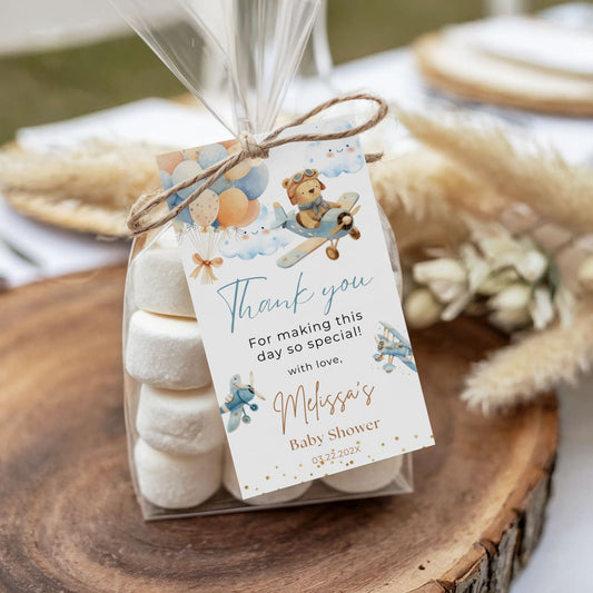 Gift bag with marshmallows and a personalized tag on a wooden surface