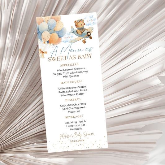 Baby shower menu card with teddy bear and balloons design on a textured background