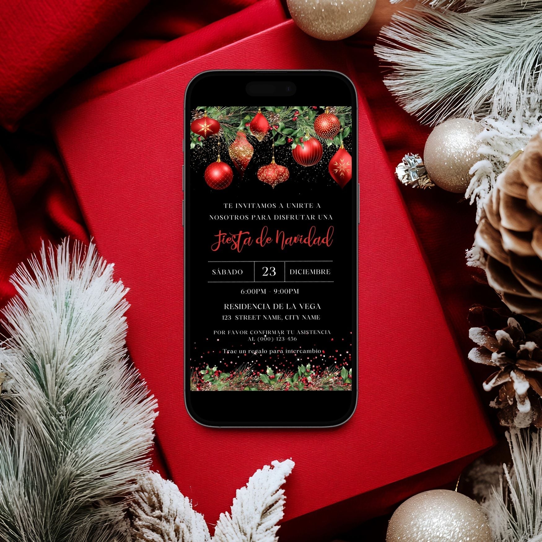 Phone displaying a Spanish Christmas party invitation on a red surface with festive decorations.