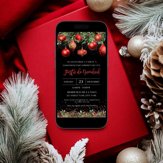 Phone displaying a Spanish Christmas party invitation on a red surface with festive decorations.