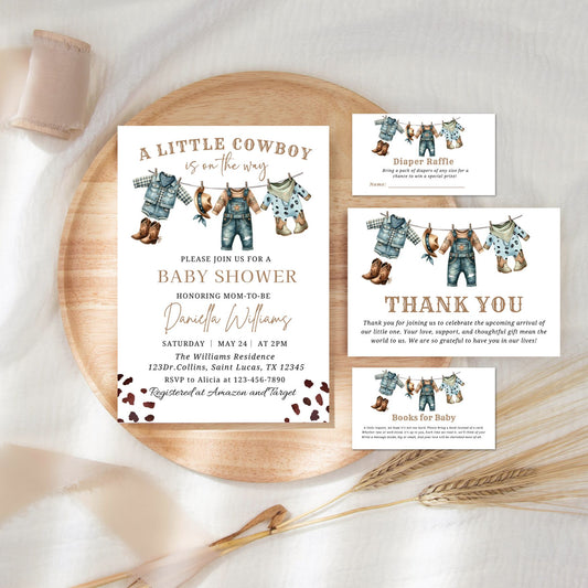 Baby shower invitation set with cowboy theme on a wooden plate.