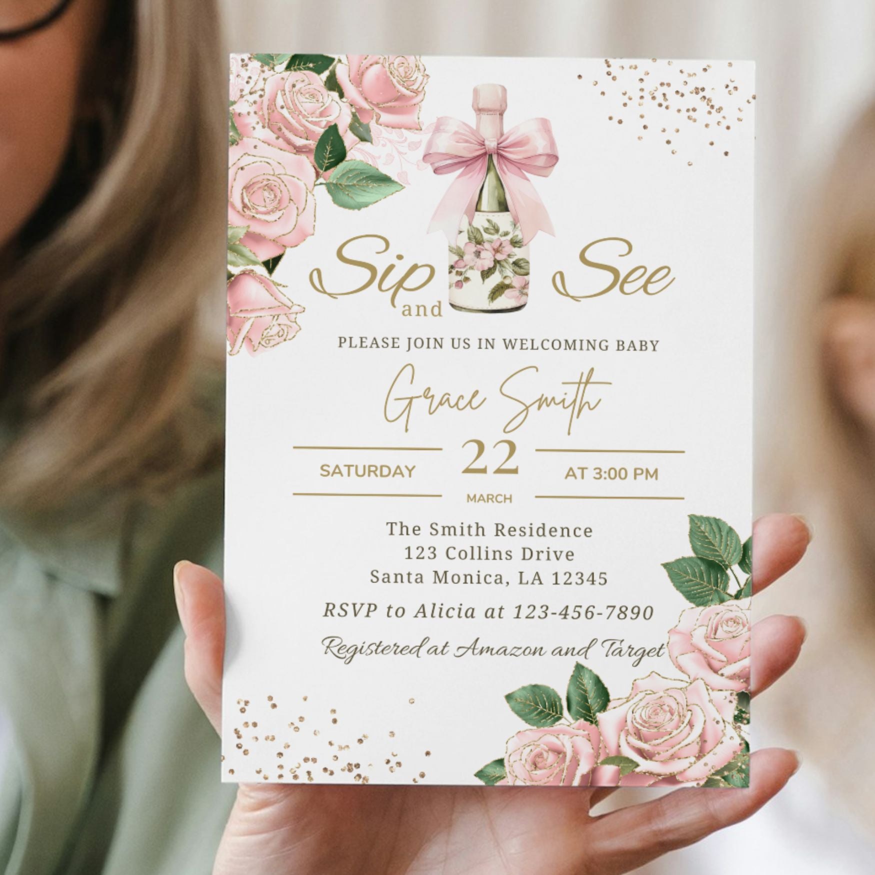 Sip and see Brunch Invitation card with pink roses and a bottle design held by a person.