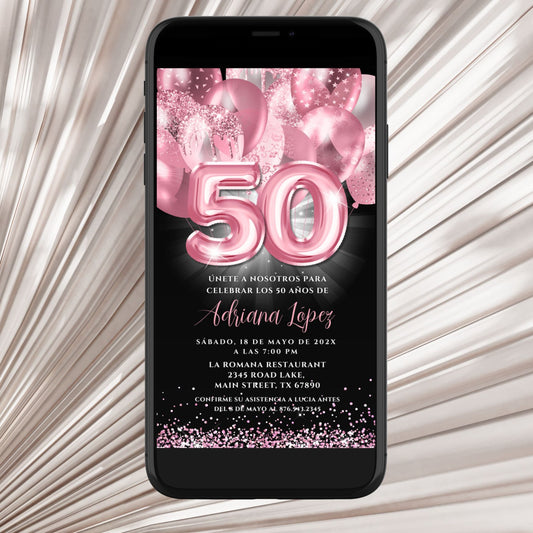 Phone displaying a birthday invitation with pink balloons and number '50' on a textured surface