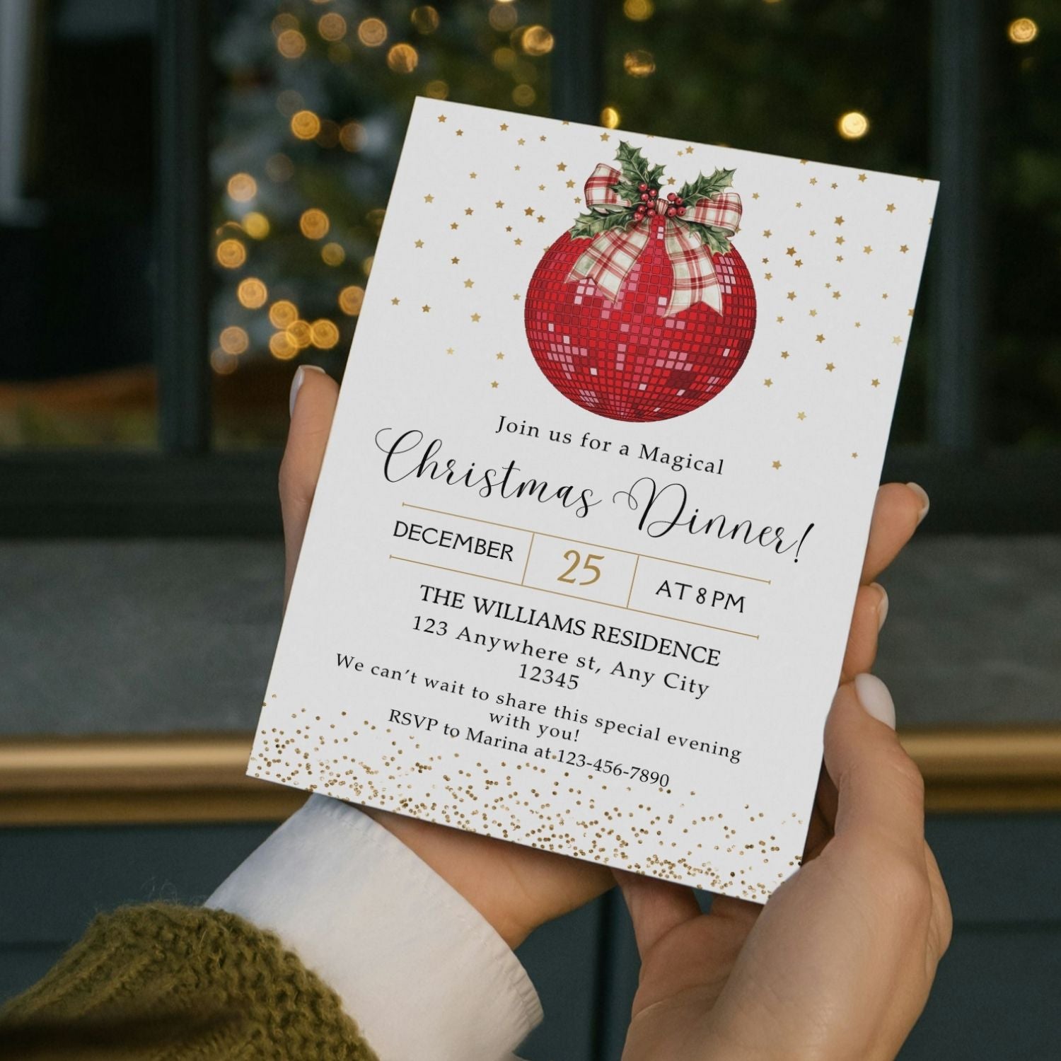 Hand holding a Disco Ball Christmas dinner invitation card with a festive design.