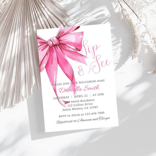 Baby shower invitation with a pink bow on a white background