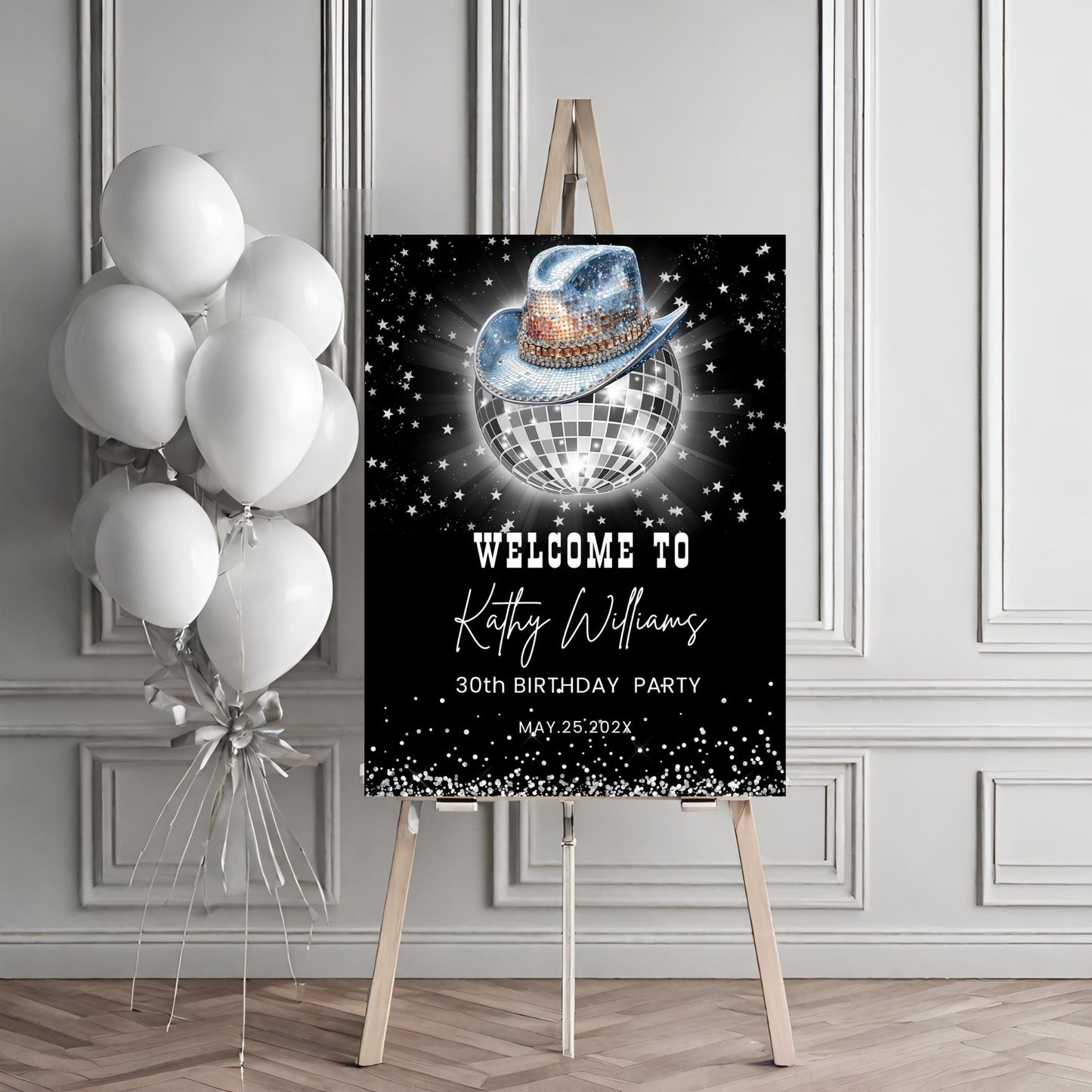 Birthday party sign with disco ball and cowboy hat design, accompanied by balloons on an easel.