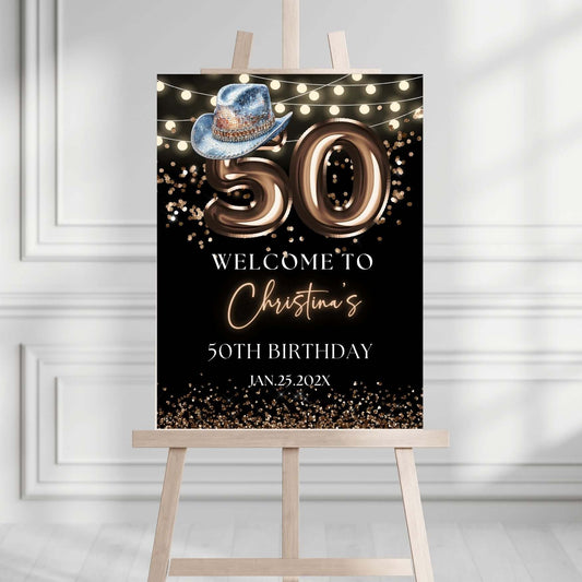 50th birthday welcome sign with Western blue hat and bronze balloons, customizable decoration for party.