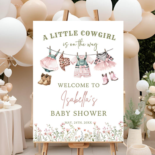 Baby shower sign with cowgirl theme decorations and balloons in the background