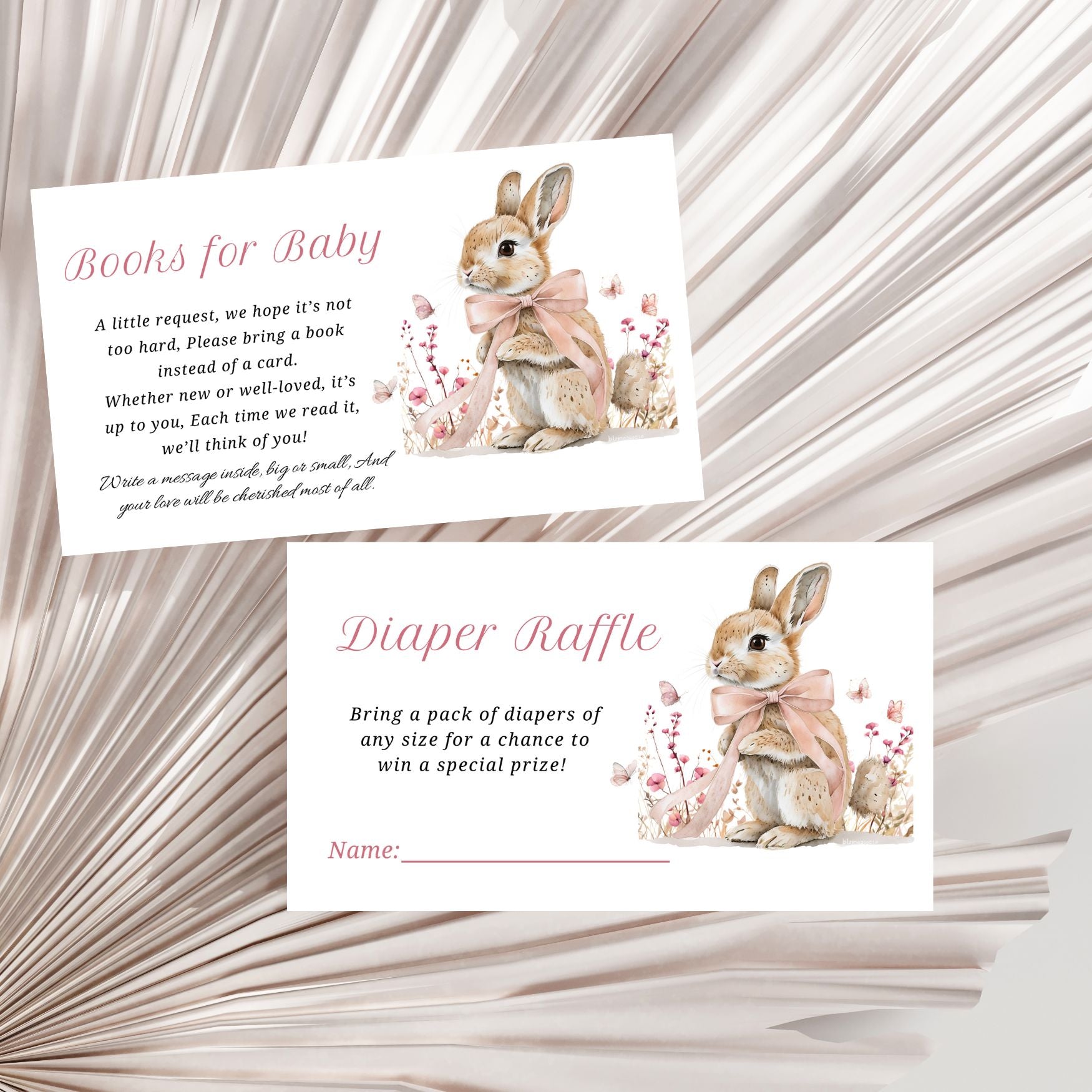 Two baby shower invitation cards with a rabbit illustration on a textured background
