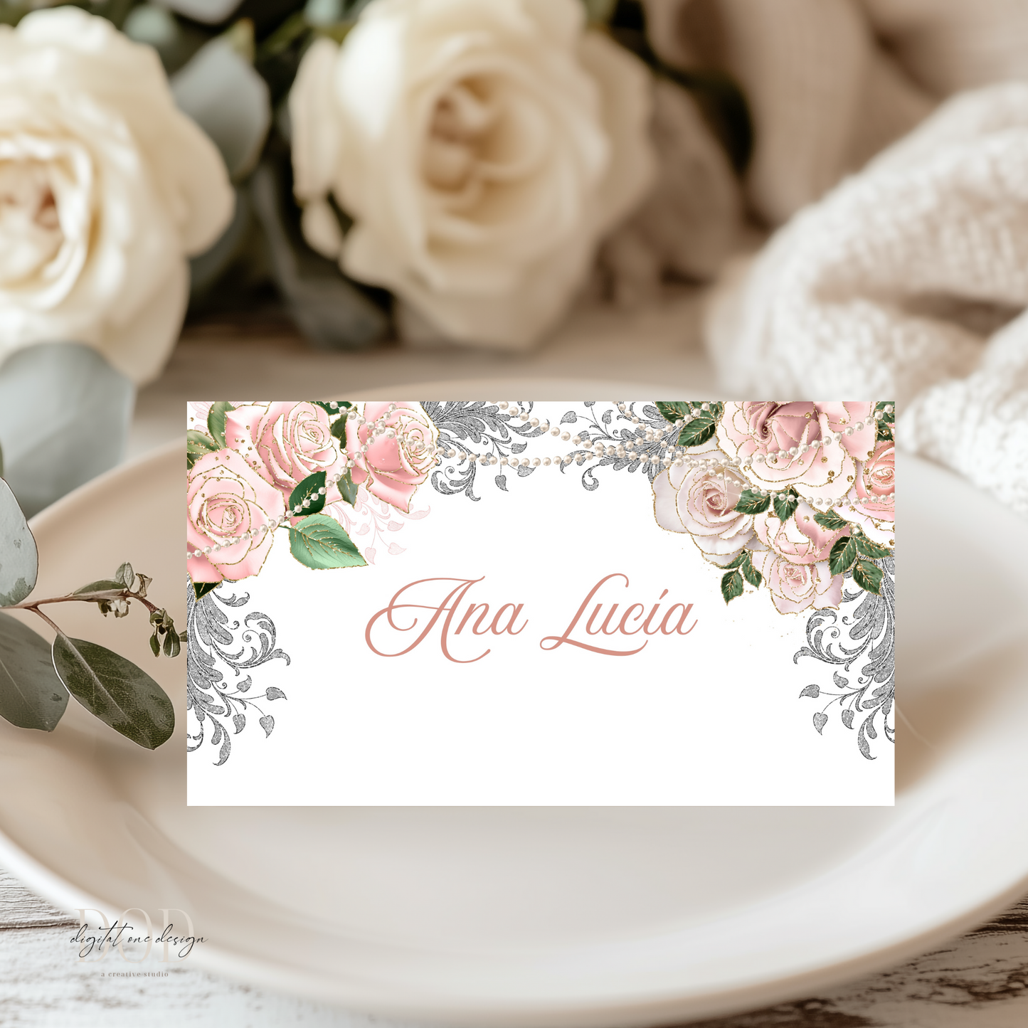 Rose Gold Floral and pearls name card with 'Ana Lucia' on a table setting with roses.