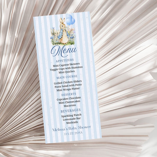 Menu card for a baby shower with a character Peter Rabbit design on a textured beige background