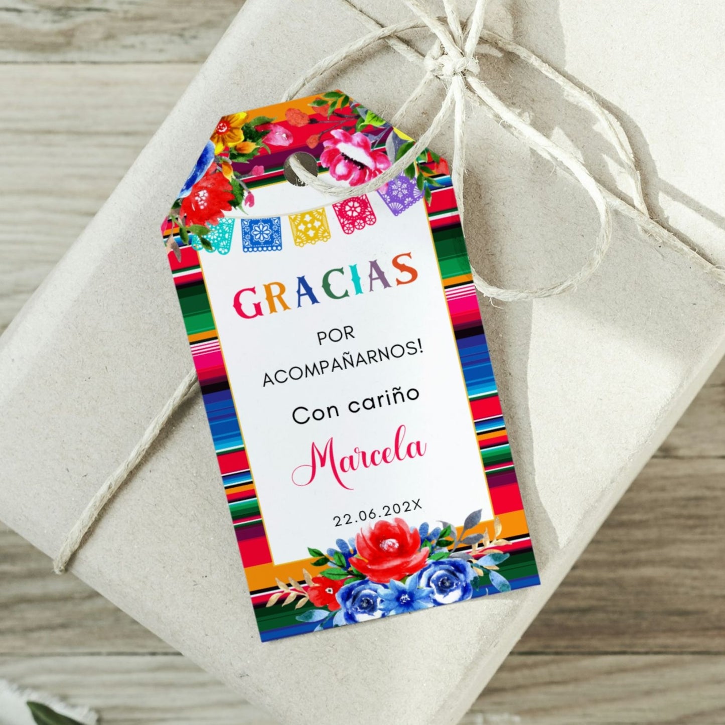 Spanish Thank you Gift tag with colorful floral ans Serape design and text on a wrapped gift.