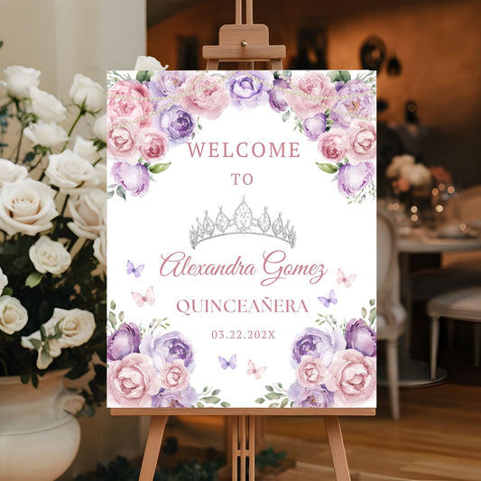 Quinceañera welcome sign with Pink floral design on an easel, surrounded by flowers.