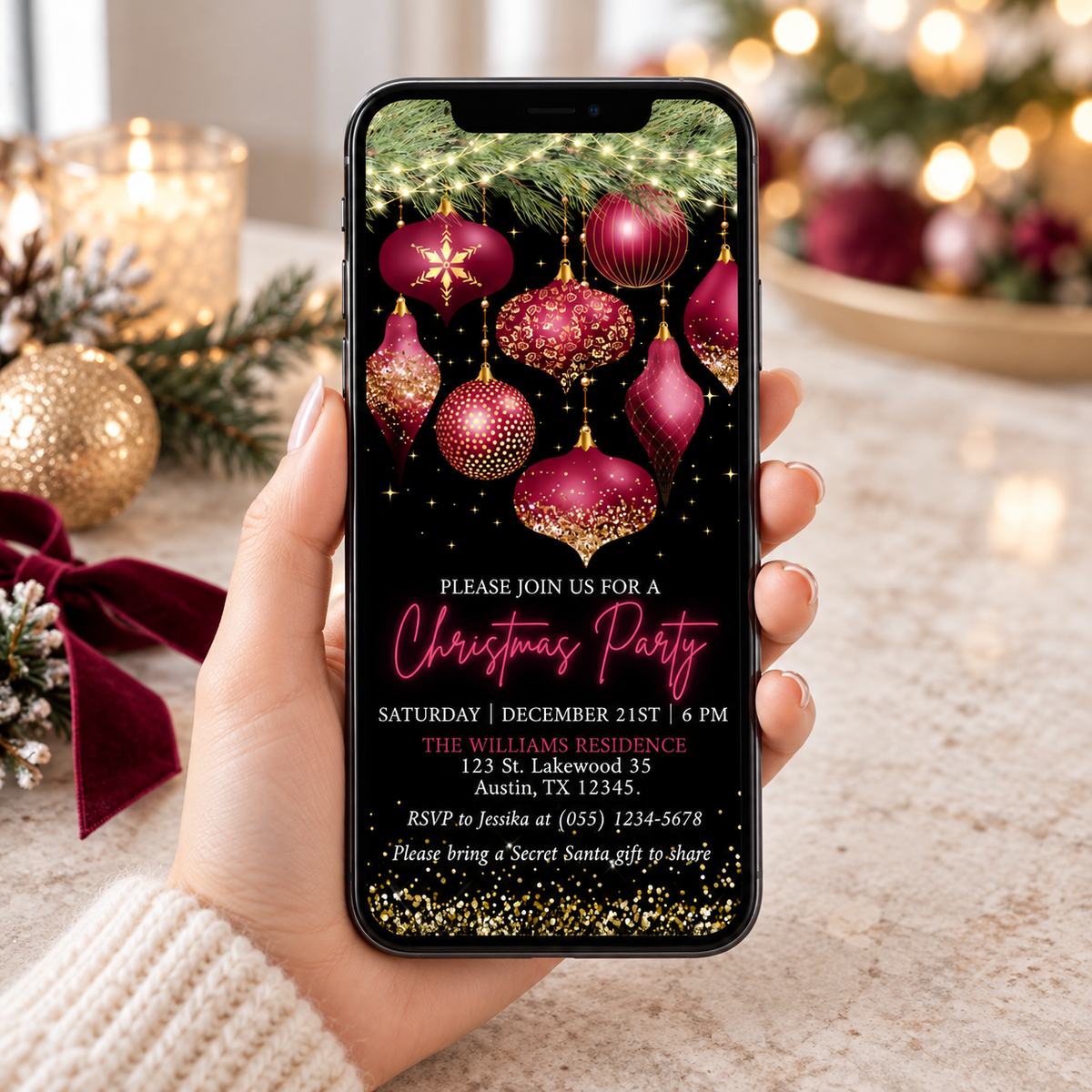Burgundy & Gold Christmas Party Invitation displayed on a smartphone with festive ornaments and RSVP details.